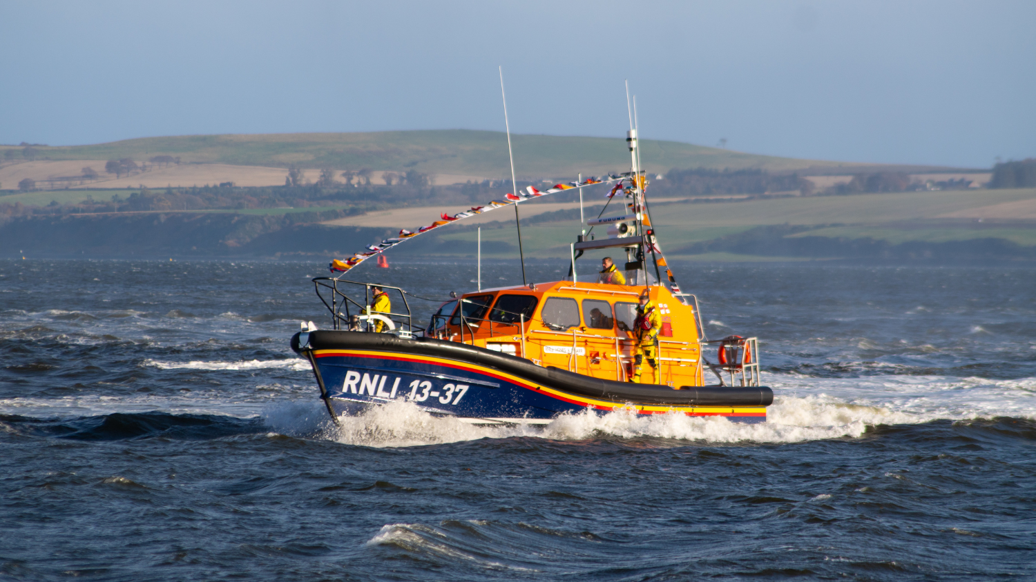 Arrival of Invergordon Shannon class lifeboat Agnes A P Barr 13-37 at station. The lifeboat has the names of donors from the Launch a Memory campaign printed on it's decal