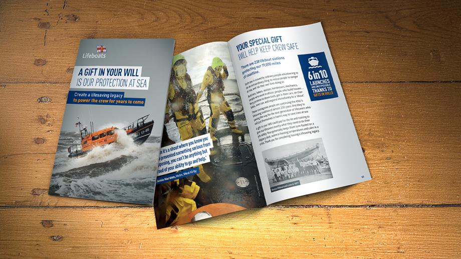 Two copies of the RNLI guide to gifts in Wills on a wooden table. One is closed, showing the front cover, and one is open showing some of the contents. 