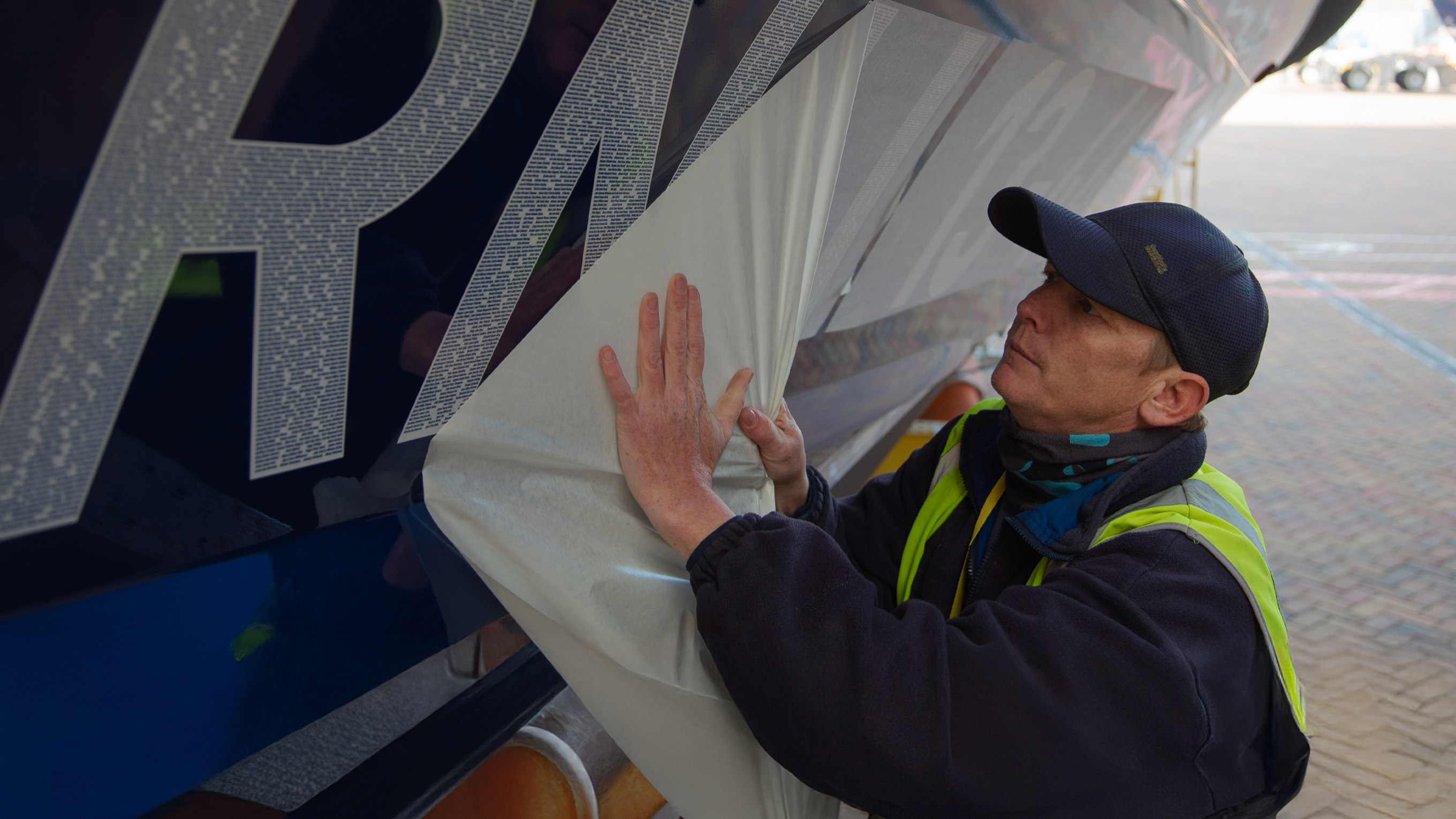 An RNLI technician applying the lifeboat number RNLI 13-44 to the hull of the first legacy lifeboat. The number contains thousands of generous supporters’ names who all left a gift in their Will to the RNLI.