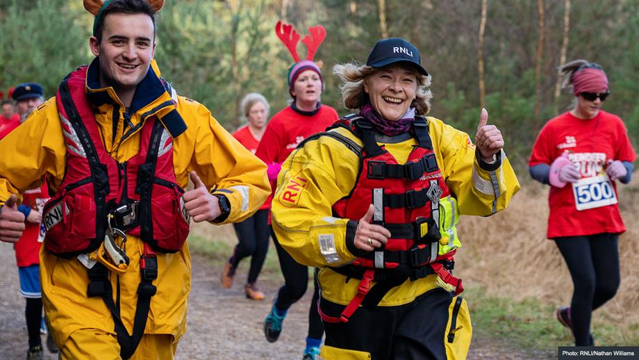 Crew members running in RNLI kit