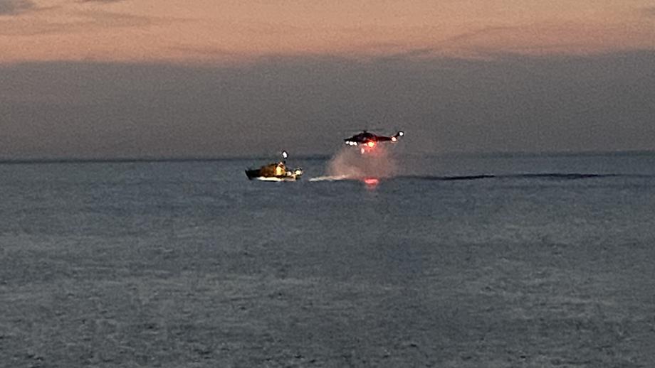 A helicopter flies above Appledore’s all-weather lifeboat, ready to winch an unresponsive swimmer