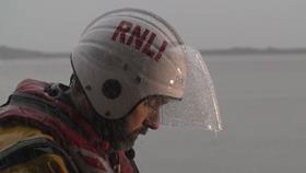 RNLI crew member in the rain