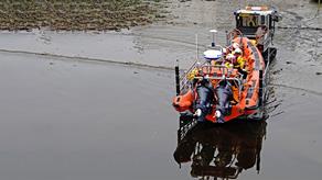 Stonehaven Lifeboat Station’s B class lifeboat being pulled out of the shallow water, and onto the shore, by the launch and recovery tractor.