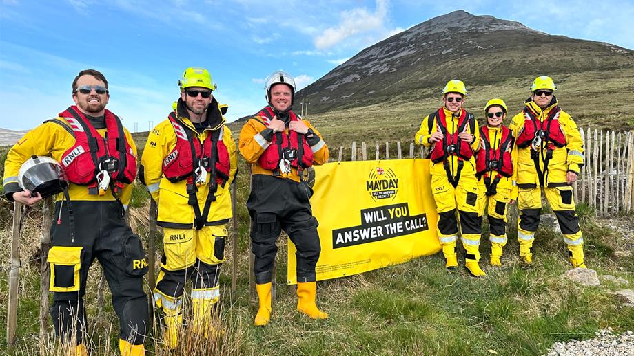Six volunteer crew members standing in front of Errigal, which they climbed to raise money for the RNLI’s Mayday campaign.