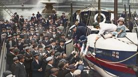 Celebrating the 100th anniversary of the RNLI, with a lifeboat in Trafalgar Square, London,  surrounded by members of the public wearing hats