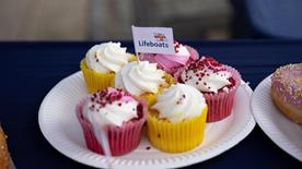 A plate of cupcakes with a mini RNLI flag