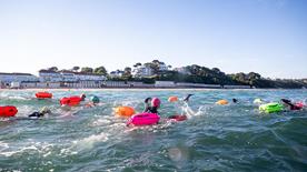 A group of swimmers with buoyancy aids in the sea