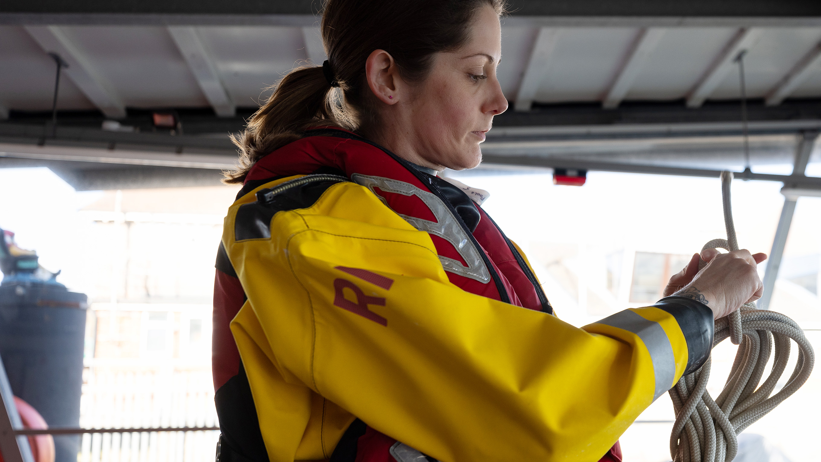 A female crew member tying up a rope.