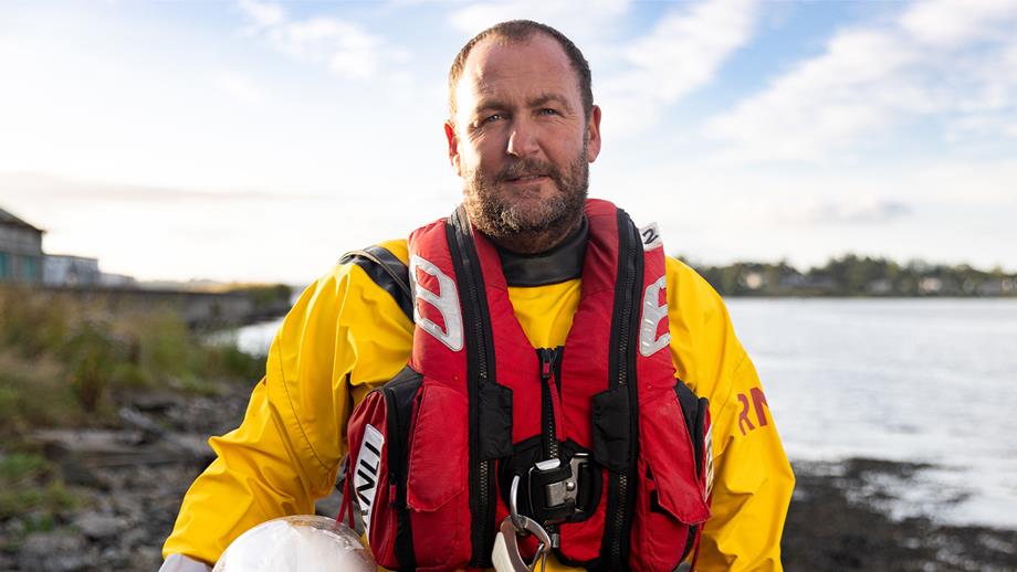 Damien Foley, Helm at Wexford Lifeboat Station, smiles at the camera.