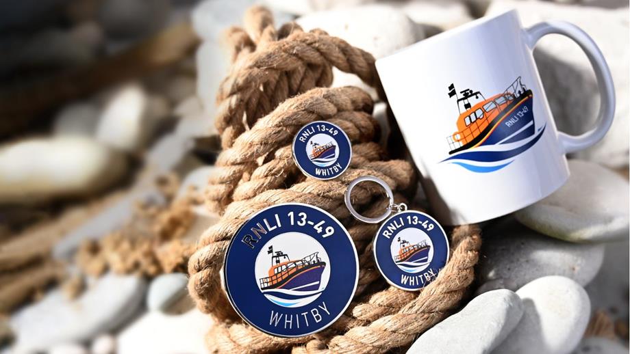 Whitby’s range of high-quality, affordable products resting on a backdrop of pebbles and a coiled rope. Mementos that show the Whitby illustration of the boat and number