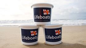 RNLI collecting buckets on the beach