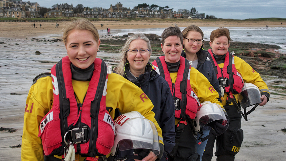 Group of female RNLI volunteers smiling