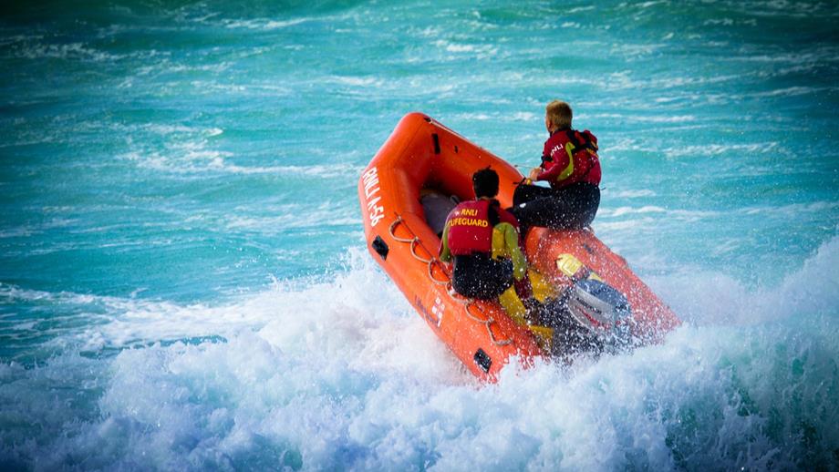Perranporth Beach lifeguards heading into the surf in their inshore rescue boat