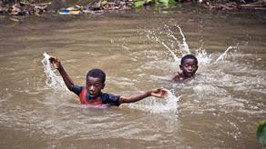 Children swimming in a river on Zanzibar