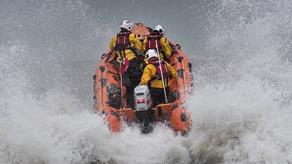 Relief D class inshore lifeboat, Robleen D-768, launching into surf at Port Talbot