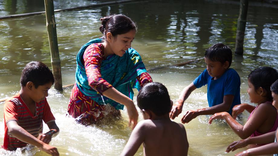 A Swim Safe teacher runs a lesson in a pond in Barisal, Bangladesh