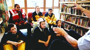 Young people learning about water safety from an RNLI education volunteer