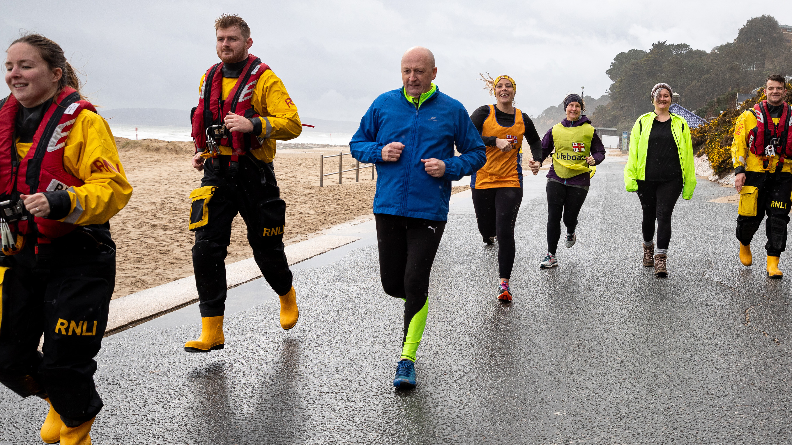 Group of Mayday Mile fundraisers running on a promenade
