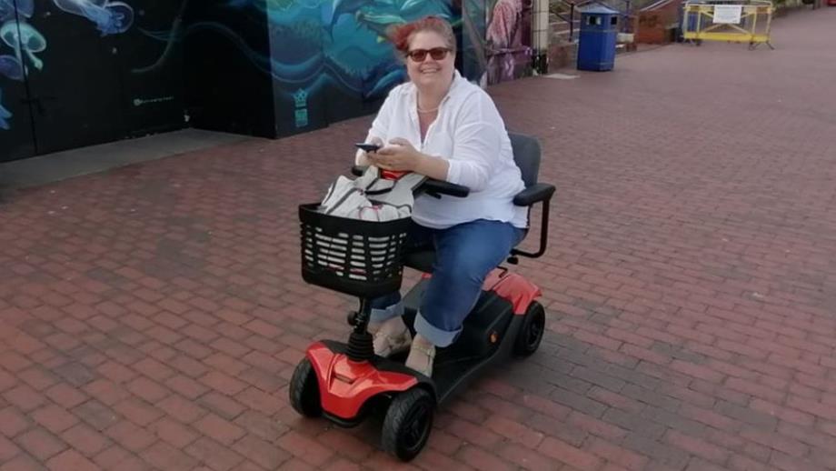 Lily uses a wheelchair and is pictured on the seafront - she raised funds for RNLI Mayday Mile challenge