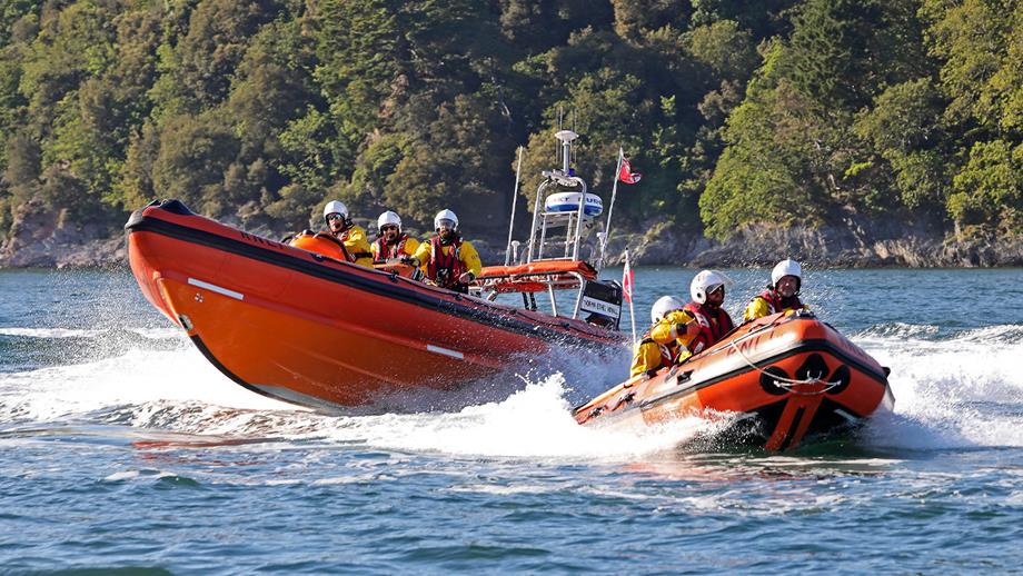A D class lifeboat and a B class lifeboat power out to sea