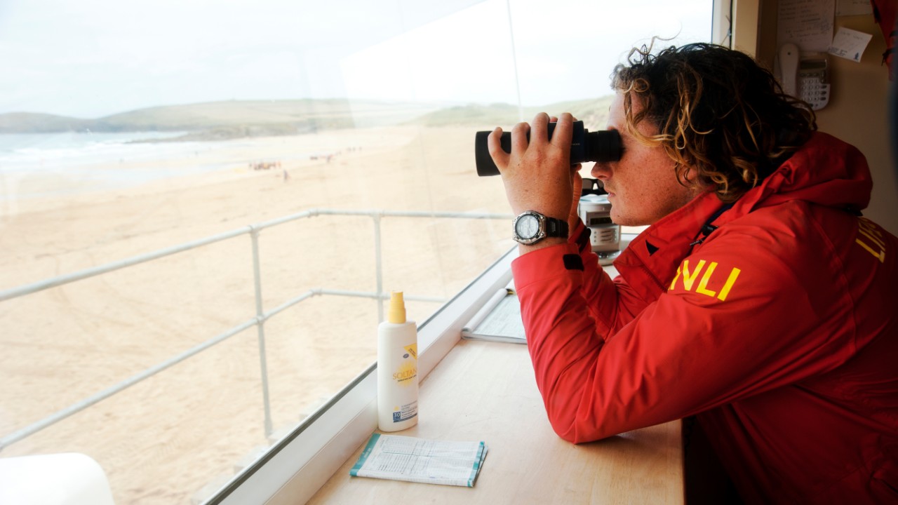 Lifeguard using binoculars